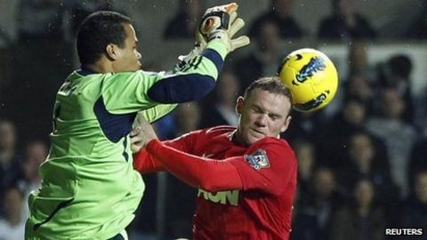 Michel Vorm beats Wayne Rooney in an aerial challenge
