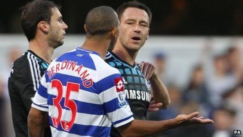England and Chelsea captain John Terry (right) speaking with QPR's Anton Ferdinand during their teams' Premier League match at Loftus Road