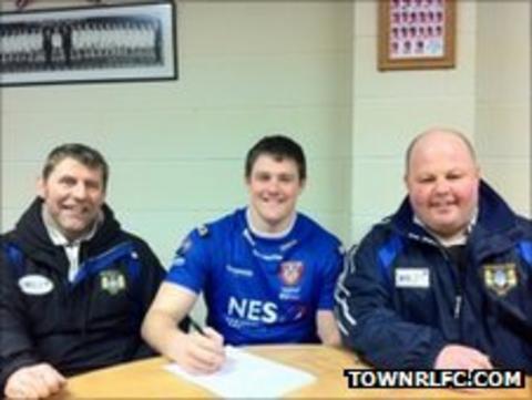 Daniel Rooney signs his contract with Martin Oglanby and Malcolm Allison