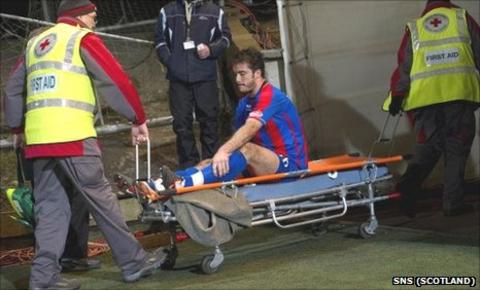 Roman Golobart on a stretcher