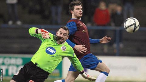 Coleraine goalkeeper Gavin Cullen in action against Philip Lowry of Linfield