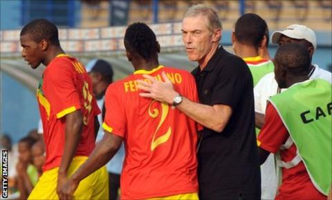 French coach Michel Dussuyer gives midfielder Pascal feindouno a pat during Guinea's group game against Botswana