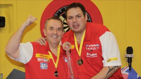 England's Phil Taylor and Adrian Lewis with the World Cup of Darts trophy