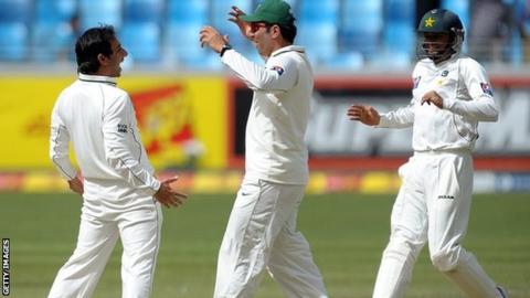 Pakistan's Saeed Ajmal, captain Misbah-ul-Haq and Azhar Ali celebrate a wicket