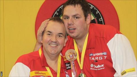 Phil Taylor and Adrian Lewis celebrate their World Cup victory in Hamburg on Sunday