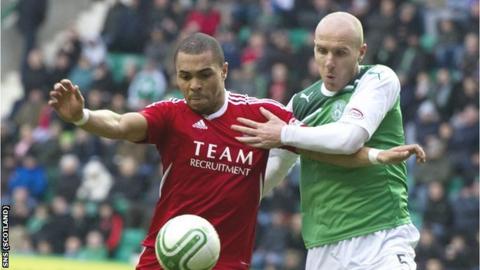 Josh Magennis tussles with Sean O'Hanlon