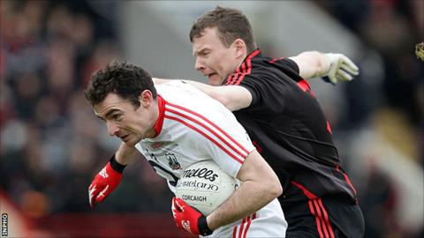 Cork's Donncha O'Connor in possession against Daniel McCartan of Down at Páirc Uí Chaoimh