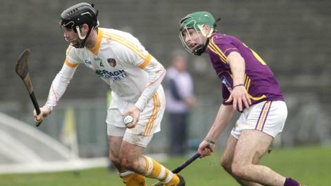 Kieran McGourty moves clear of Wexford's Gary Moore at Casement Park