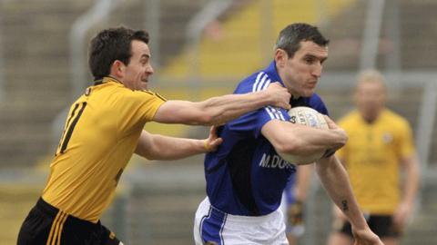 Mark Poland tackles Munster's Graham Canty at the Athletic Grounds