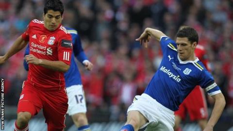Mark Hudson (right) challenging Liverpool's Luis Suarez
