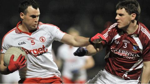 Cathal McCarron holds off Westmeath's Kieran Gavin at Healy Park