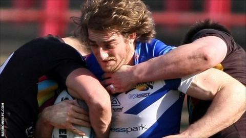 Liam Harrison for Barrow tackled by North Wales Crusaders players
