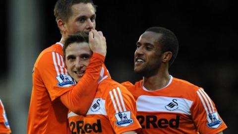 Gylfi Sigurdsson, Joe Allen and Wayne Routledge celebrate Swansea City's win over Fulham