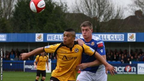 Newport County’s Nat Jarvis holds off Wealdstone’s Alan Massey