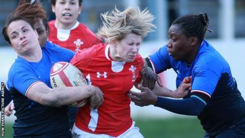 Mared Evans is tackled by France's Poublan Elode and Djossouvi Koumiba
