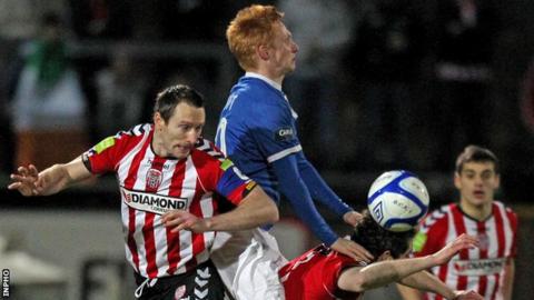 Derry's Barry Molloy challenges Linfield's Robert Garrett in the Brandywell game