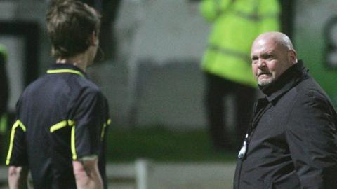 A match official discusses a decision with David Jeffrey during the Brandywell game