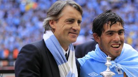 Roberto Mancini and Carlos Tevez celebrate after winning the FA Cup in 2011