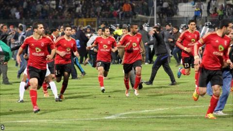 Al-Ahly players flee the pitch in Port Said