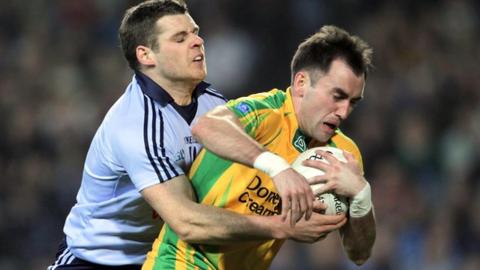 Dublin's Kevin McMenamon tackles Karl Lacey in the league clash