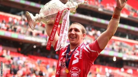 Ryan Hoffman of Wigan Warriors celebrates by lifting the Carnegie Cup