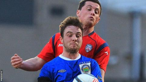 Jamie Mulgrew battles with Ruairi Harkin at Windsor Park