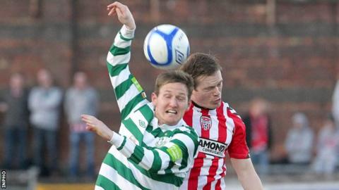 Gary Twigg battles with Derry's Simon Madden at the Brandywell