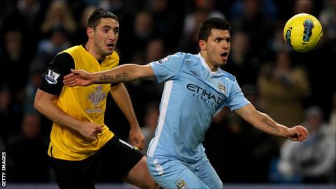 Blackburn Rovers defender Bradley Orr (l) challenges Sergio Aguero