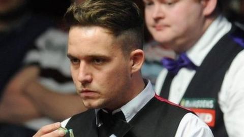 Jamie Jones lines up a shot as Shaun Murphy looks on