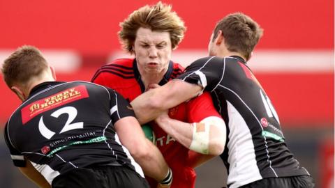 Munster A's Danny Barnes is tackled by Phil Williams and Jason Tovey