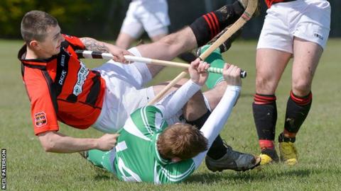 Liam Girvan (Glenurquhart) falls over the grounded Martin Davidson (Beauly) at Braeview Park
