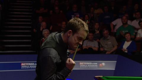 Ali Carter celebrates beating Judd Trump