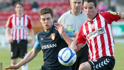 St Pat's John Russell battles with Stephen McLaughlin at the Brandywell