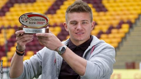 Motherwell defender Shaun Hutchinson shows off his award