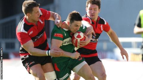 Llanelli's Jordan Williams is tackled by Aberavon's Richard Thomas