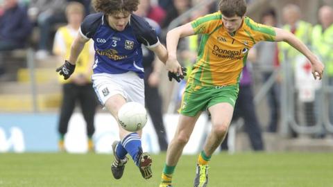 Cavan's Conor Smyth is challenged by Dara Mulgrew in the minor game