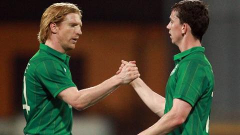 Paul McShane and Kevin Foley shake hands at the end of the friendly against a Tuscan Select
