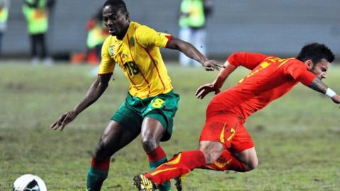 Cameroon's Enoh Eyong (in yellow)