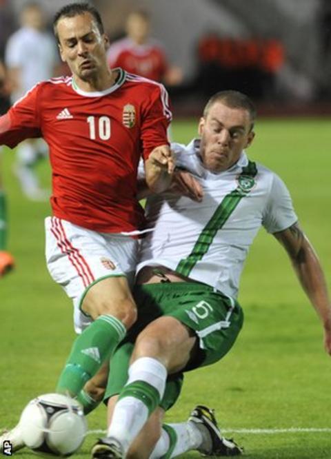 Hungary's Peter Szakaly is tackled by Republic of Ireland defender Richard Dunne