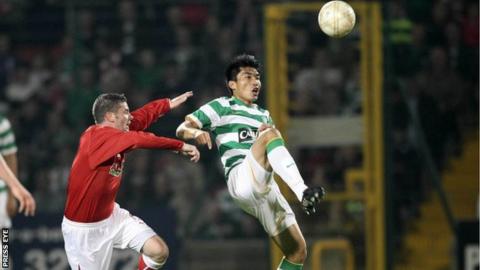 Chris Scannell battles with Celtic's Zhi Zheng in the 2009 friendly at Solitude