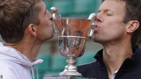 Max Mirnyi, left, and Daniel Nestor kiss the trophy after winning the men's doubles final against Bob and Mike Bryan at the French Open