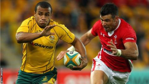 Australia scrum-half Will Genia runs away from opposite number Mike Phillips