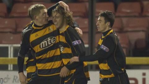 May (centre) celebrates scoring a goal while on loan with Alloa
