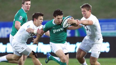 Foster Horan is tackled by two England opponents