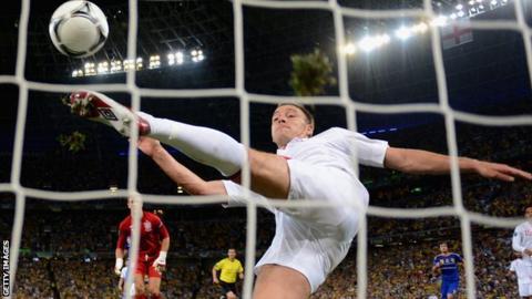 John Terry hooks away Marko Devic's shot just after it crosses the line
