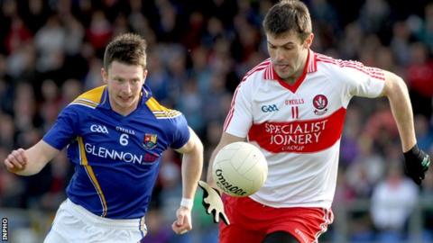 Longford's Michael Quinn in action against Mark Lynch of Derry