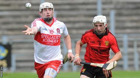 Derry's Paddy Henry in action against Andy Savage of Down in the Ulster hurling semi-final