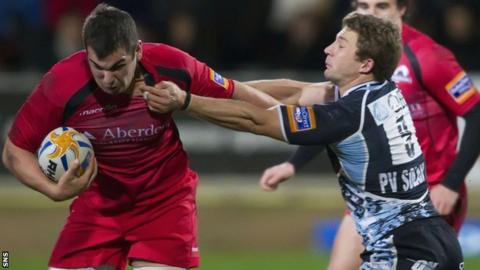 Edinburgh's Stuart McInally is tackled by Chris Cusiter