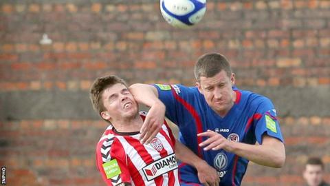 Derry debutant Conor Murphy battles with Jason McGuinness