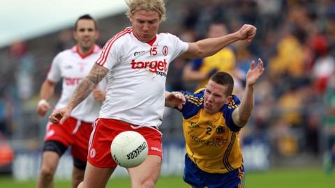 Owen Mulligan shoots despite the efforts of Seanie McDermott